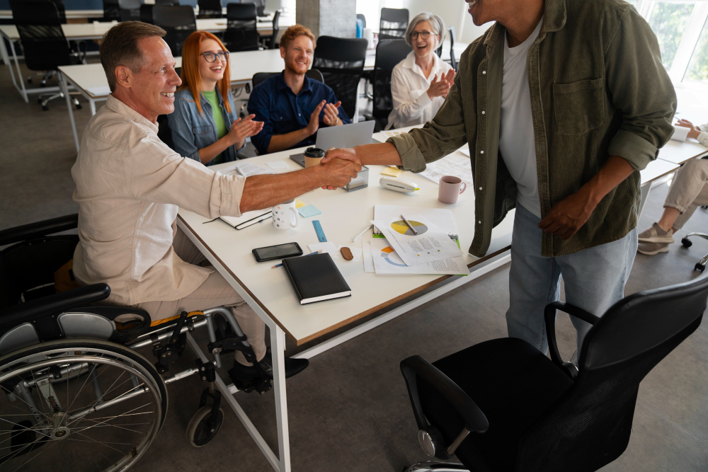 a happy man on a wheelchair doing a handshake